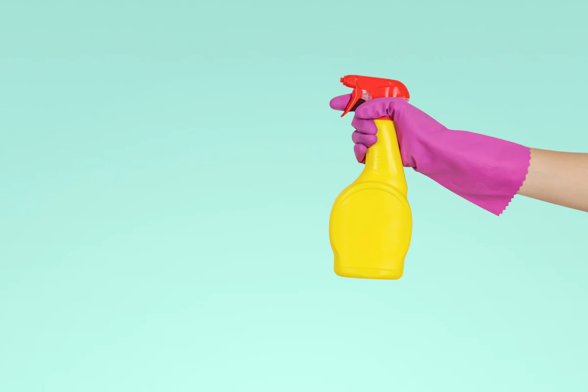 Bonded and insured Hypermaids cleaner holding professional grade cleaning supplies included in every flat rate